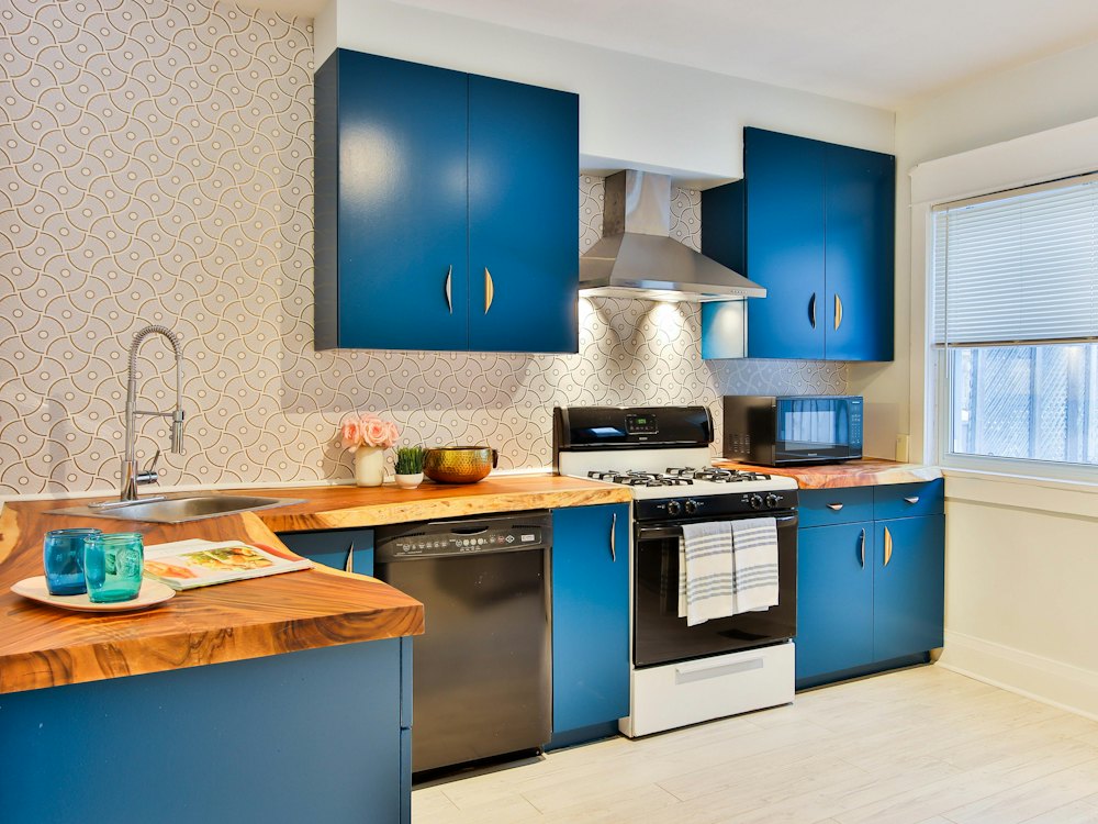Small kitchen with painted blue cabinets and wood countertops